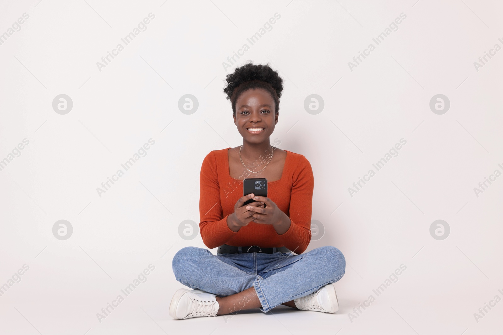 Photo of Happy woman with smartphone on white background