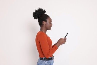 Photo of Happy woman with smartphone on white background