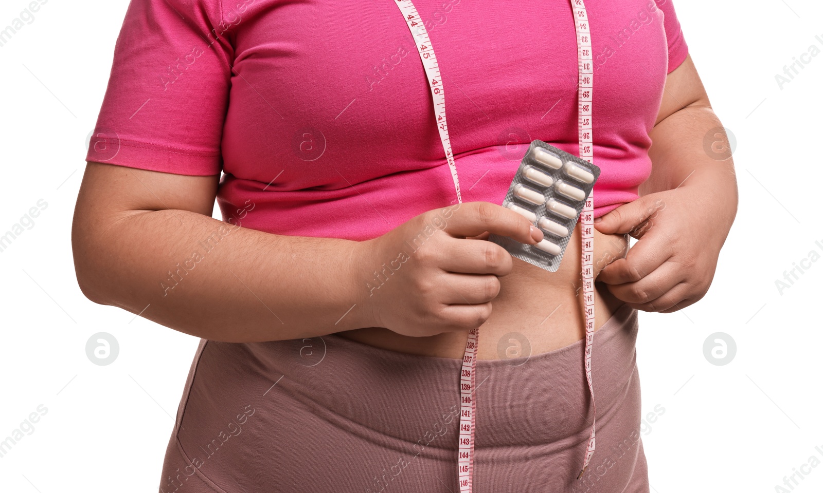 Photo of Plus size woman holding blister of weight loss supplements on white background, closeup