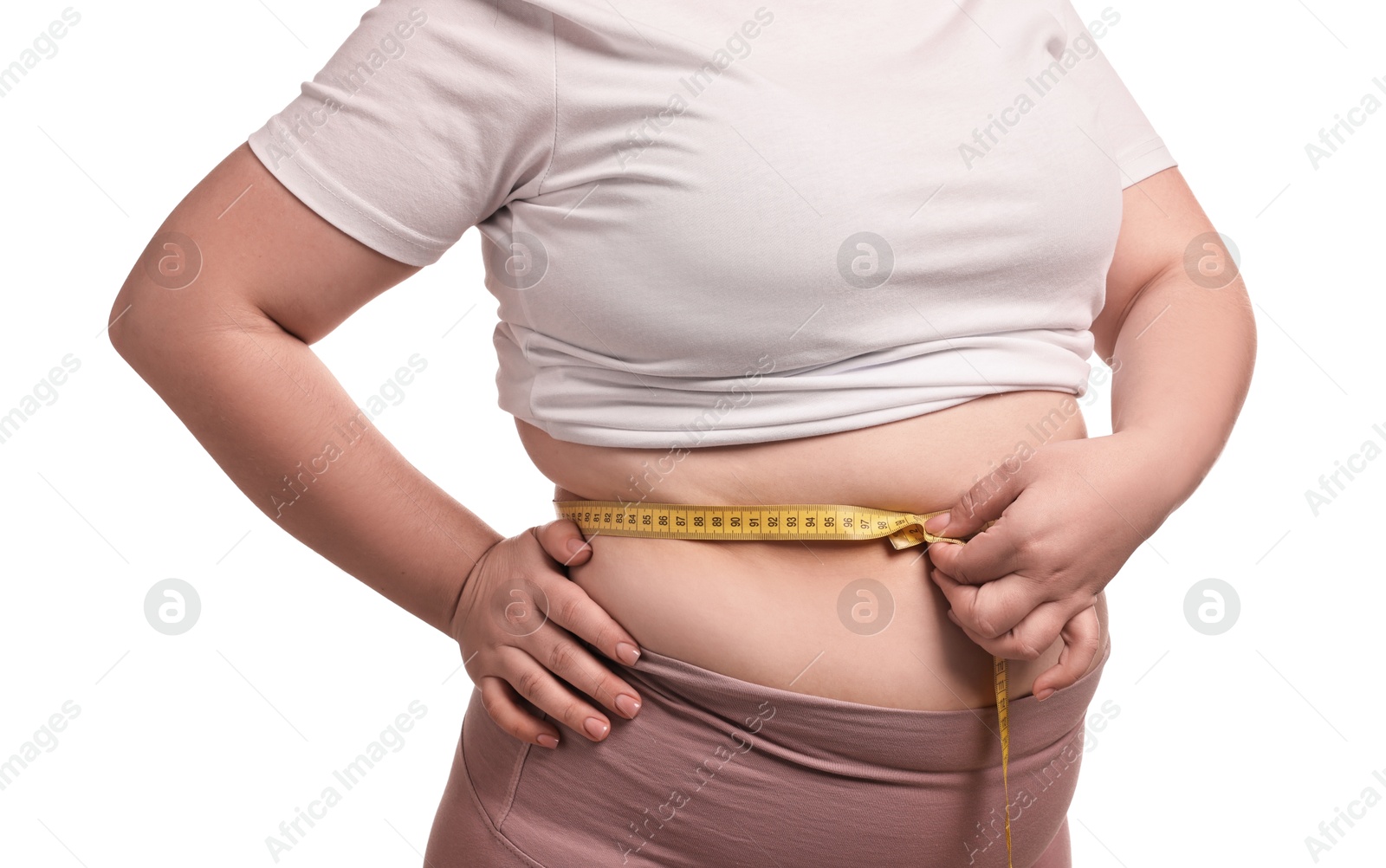 Photo of Weight loss. Plus size woman measuring waist with tape on white background, closeup