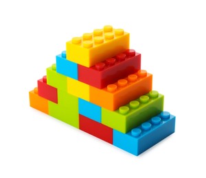 Photo of Construction toy. Pyramid made with building bricks isolated on white