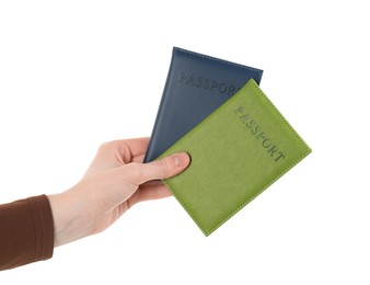 Photo of Woman holding passports in color covers on white background, closeup