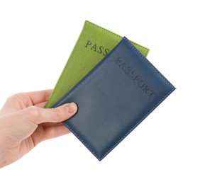 Photo of Woman holding passports in color covers on white background, closeup