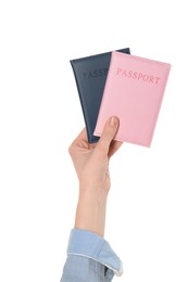 Photo of Woman holding passports in color covers on white background, closeup