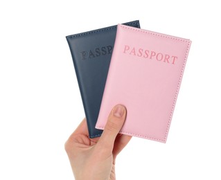 Photo of Woman holding passports in color covers on white background, closeup