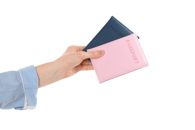 Photo of Woman holding passports in color covers on white background, closeup