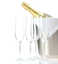 Bottle of champagne in ice bucket and empty glasses isolated on white