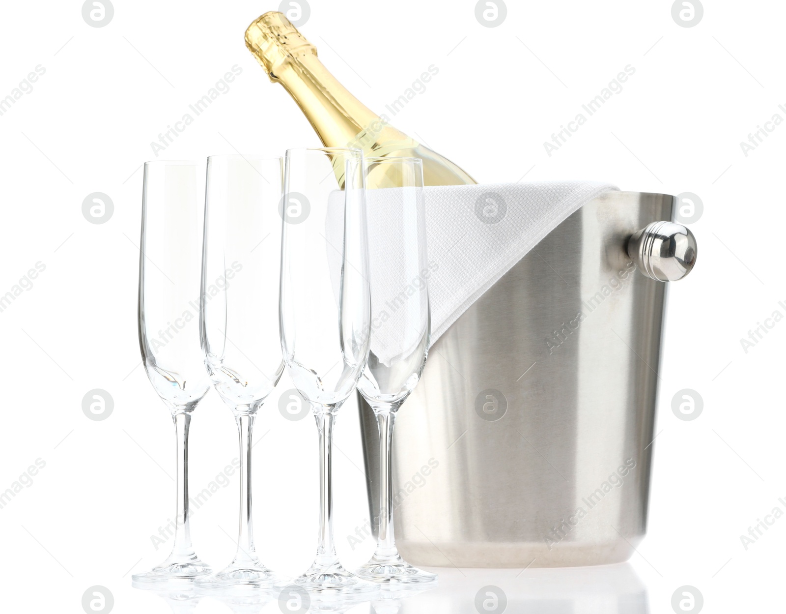 Photo of Bottle of champagne in ice bucket and empty glasses isolated on white