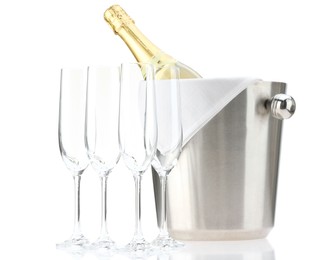 Bottle of champagne in ice bucket and empty glasses isolated on white