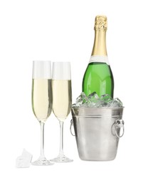 Photo of Champagne in glasses and ice bucket with bottle isolated on white