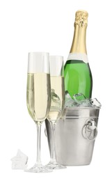 Champagne in glasses and ice bucket with bottle isolated on white