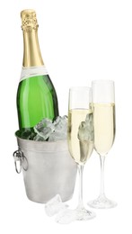 Photo of Champagne in glasses and ice bucket with bottle isolated on white