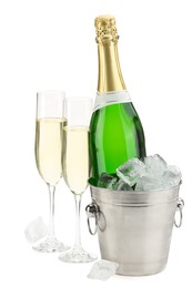 Photo of Champagne in glasses and ice bucket with bottle isolated on white