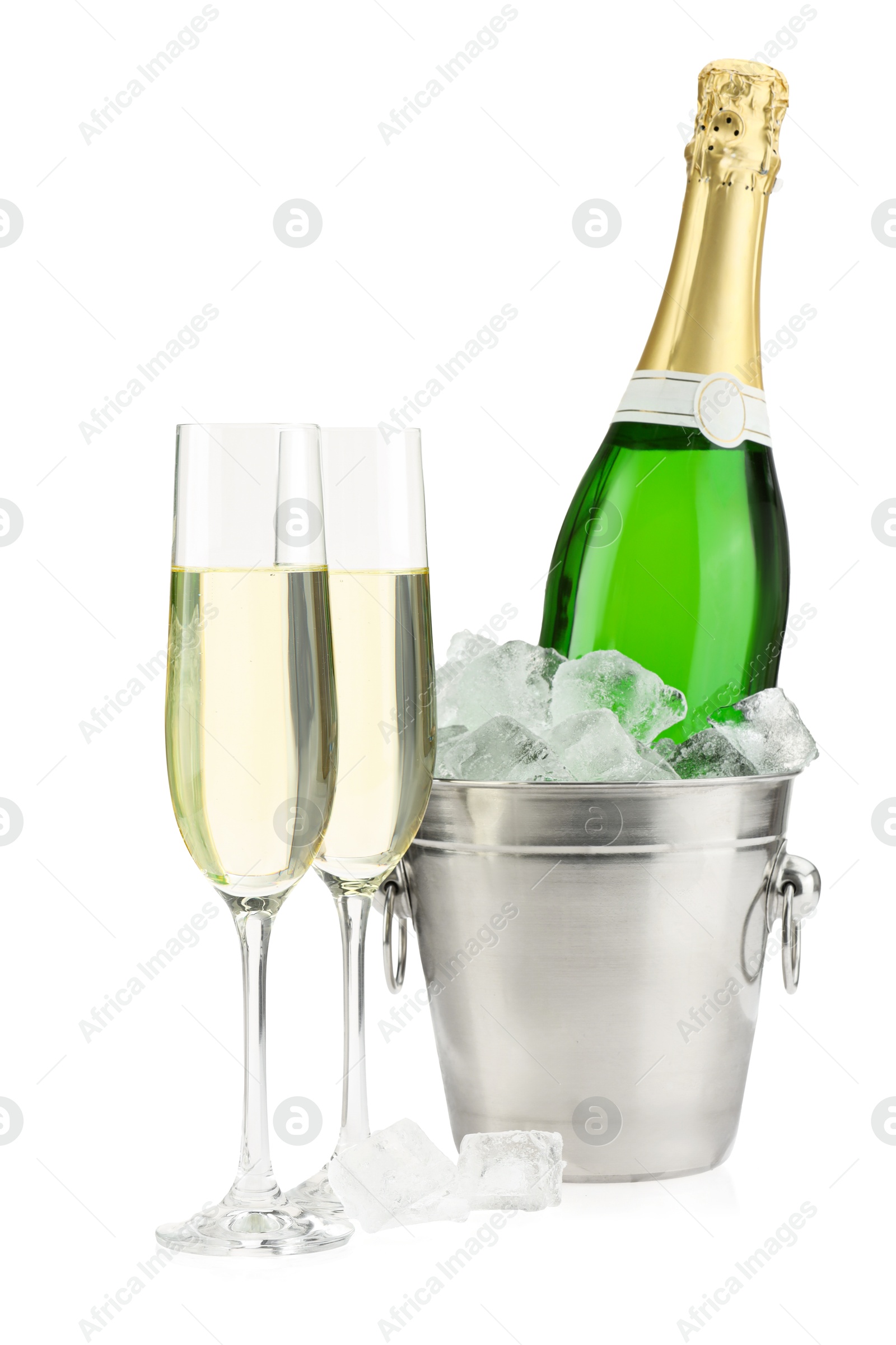 Photo of Champagne in glasses and ice bucket with bottle isolated on white