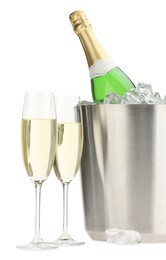 Photo of Champagne in glasses and ice bucket with bottle isolated on white