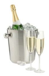 Photo of Champagne in glasses and ice bucket with bottle isolated on white