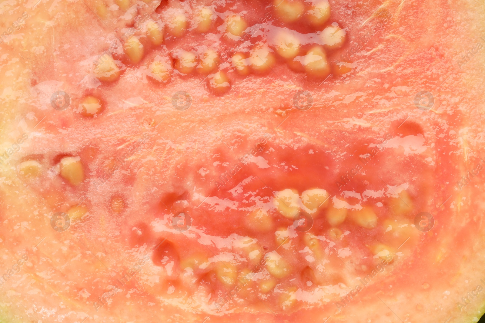 Photo of Juicy guava fruit with seeds as background, top view