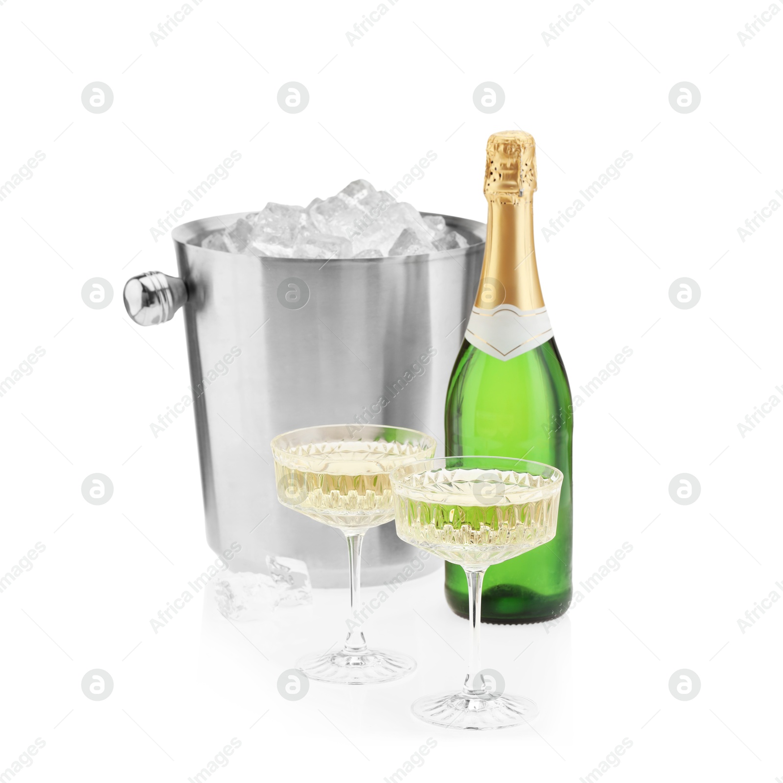 Photo of Champagne in glasses, bottle and ice bucket isolated on white