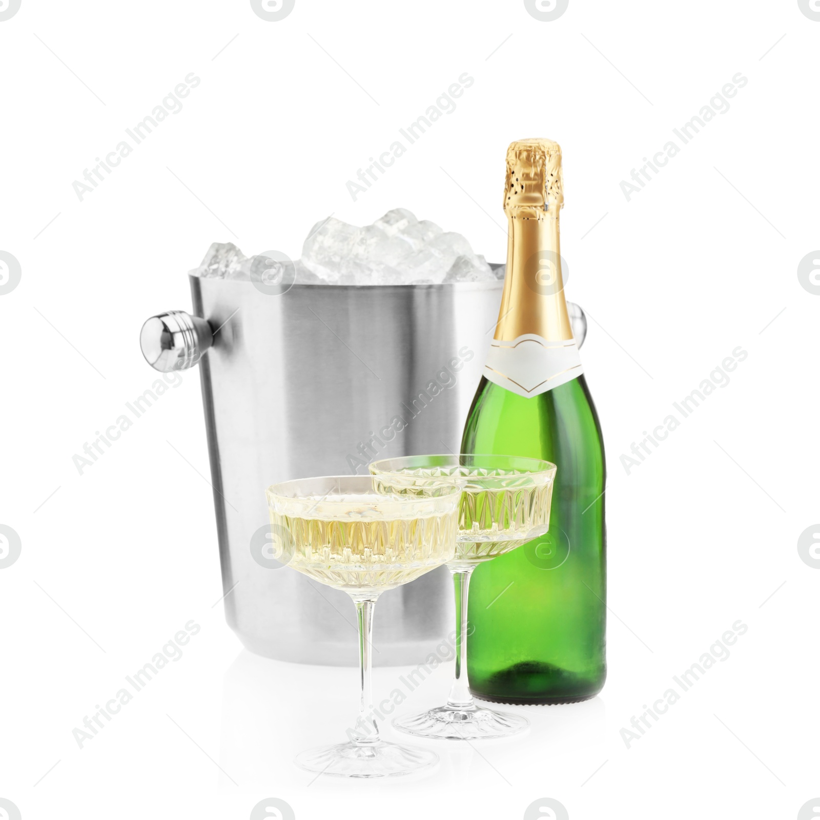 Photo of Champagne in glasses, bottle and ice bucket isolated on white