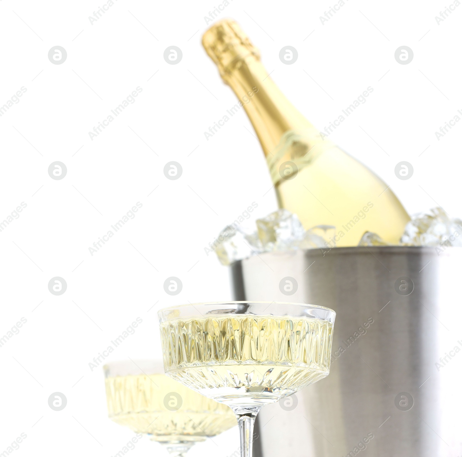 Photo of Champagne in glasses and ice bucket with bottle isolated on white