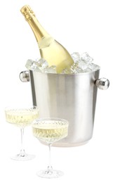 Photo of Champagne in glasses and ice bucket with bottle isolated on white