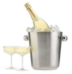 Photo of Champagne in glasses and ice bucket with bottle isolated on white