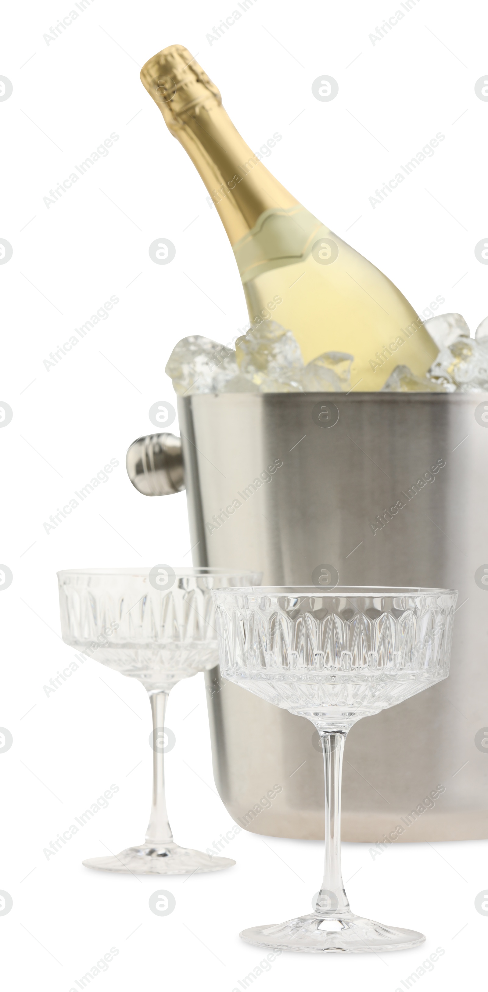 Photo of Bottle of champagne in ice bucket and empty glasses isolated on white