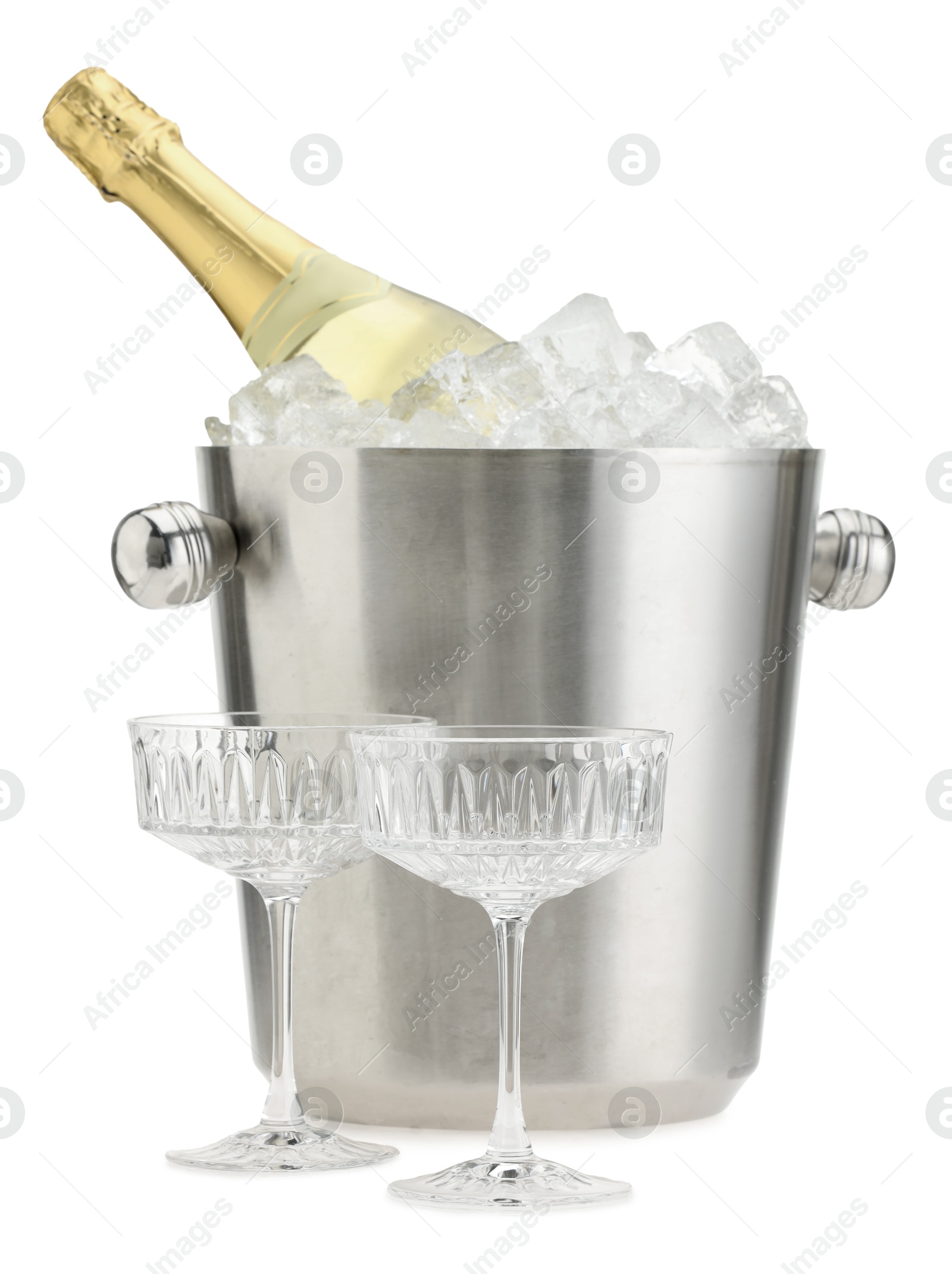 Photo of Bottle of champagne in ice bucket and empty glasses isolated on white