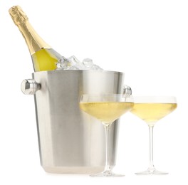 Photo of Champagne in glasses and ice bucket with bottle isolated on white