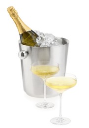 Photo of Champagne in glasses and ice bucket with bottle isolated on white