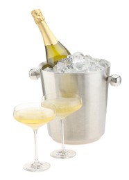 Photo of Champagne in glasses and ice bucket with bottle isolated on white