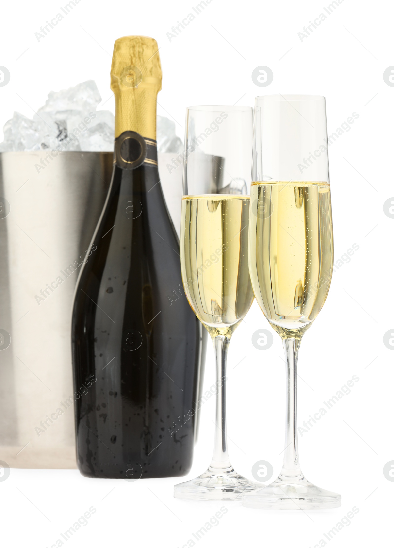 Photo of Champagne in glasses, bottle and ice bucket isolated on white