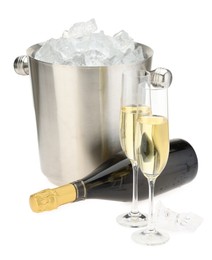 Photo of Champagne in glasses, bottle and ice bucket isolated on white