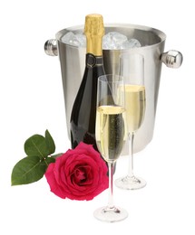 Photo of Champagne in glasses, bottle, beautiful rose and ice bucket isolated on white