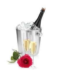 Champagne in glasses, beautiful rose and ice bucket with bottle isolated on white