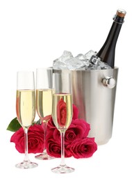 Champagne in glasses, beautiful roses and ice bucket with bottle isolated on white