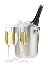 Champagne in glasses and ice bucket with bottle isolated on white