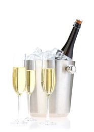 Photo of Champagne in glasses and ice bucket with bottle isolated on white