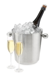 Photo of Champagne in glasses and ice bucket with bottle isolated on white