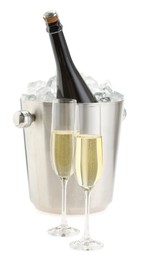 Photo of Champagne in glasses and ice bucket with bottle isolated on white