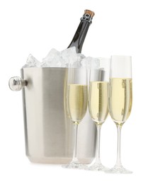 Photo of Champagne in glasses and ice bucket with bottle isolated on white