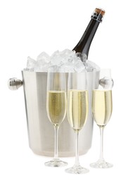 Photo of Champagne in glasses and ice bucket with bottle isolated on white