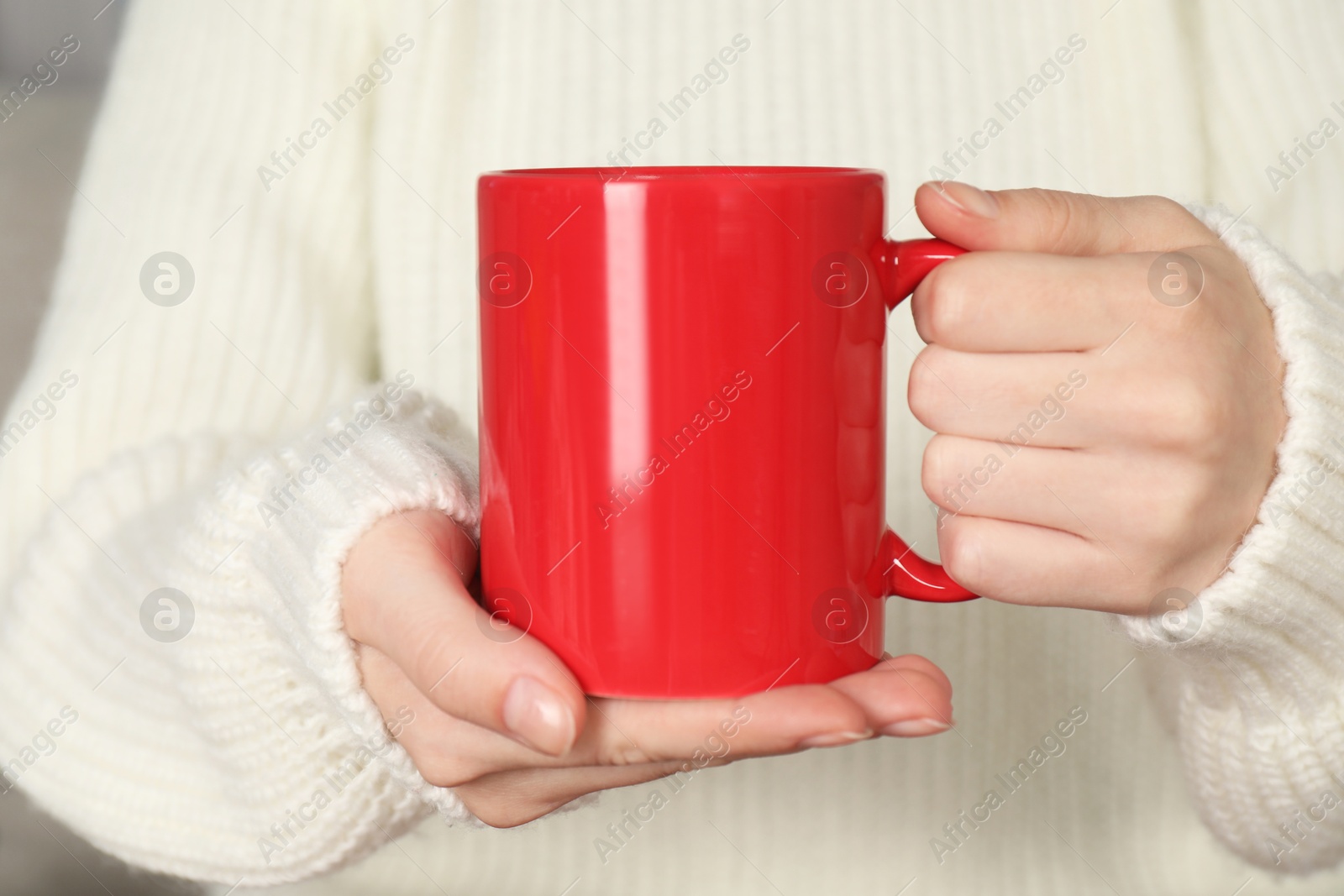 Photo of Woman with red ceramic cup, closeup. Mockup for design