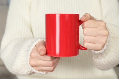 Photo of Woman with red ceramic cup, closeup. Mockup for design