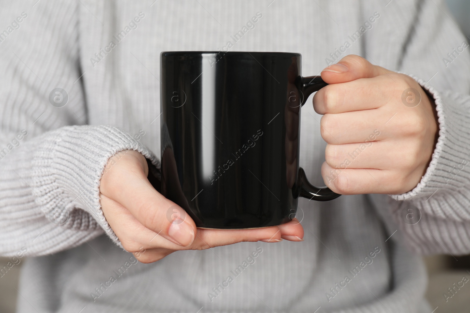 Photo of Woman with black ceramic cup, closeup. Mockup for design