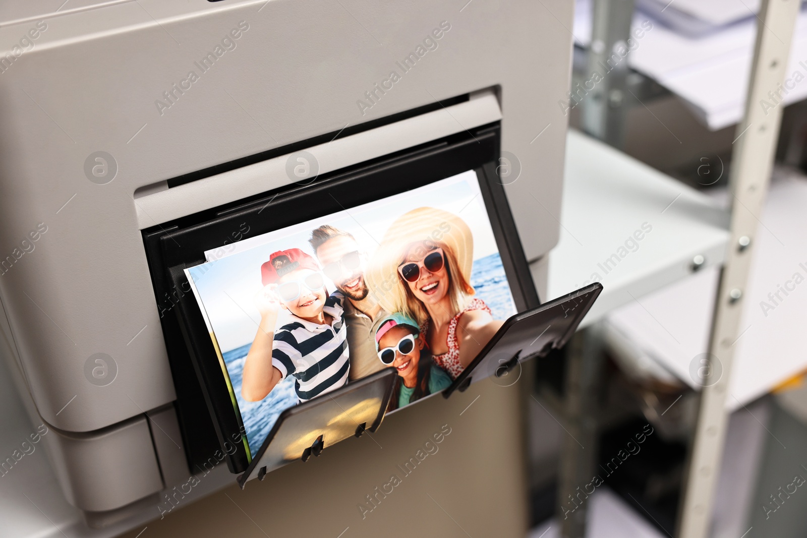 Photo of Modern printer with colorful photo indoors, closeup