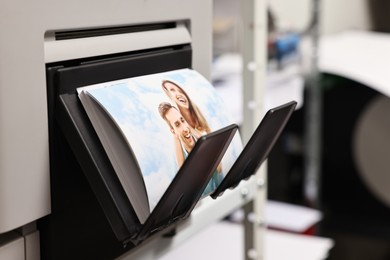 Photo of Modern printer with colorful photo indoors, closeup