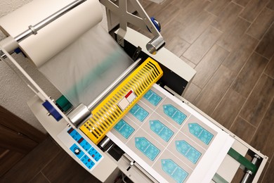 Photo of Modern roll laminator with paper indoors, above view