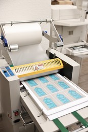 Photo of Modern roll laminator with paper indoors, closeup