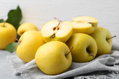 Photo of Fresh ripe yellow apples on grey table, closeup